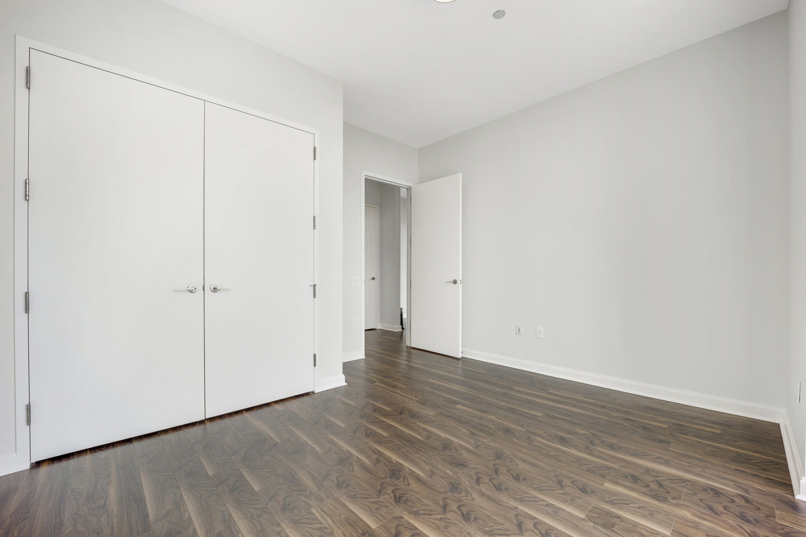 111 West Wacker Drive, Unit PH01 Chicago, IL 60601 - Photo 22 of 37 a view of an empty room with wooden floor