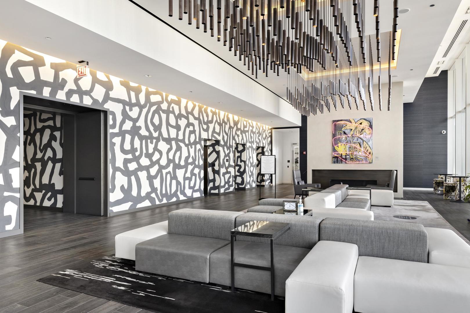 111 West Wacker Drive, Unit PH01 Chicago, IL 60601 - Photo 24 of 37 a living room with furniture and a chandelier