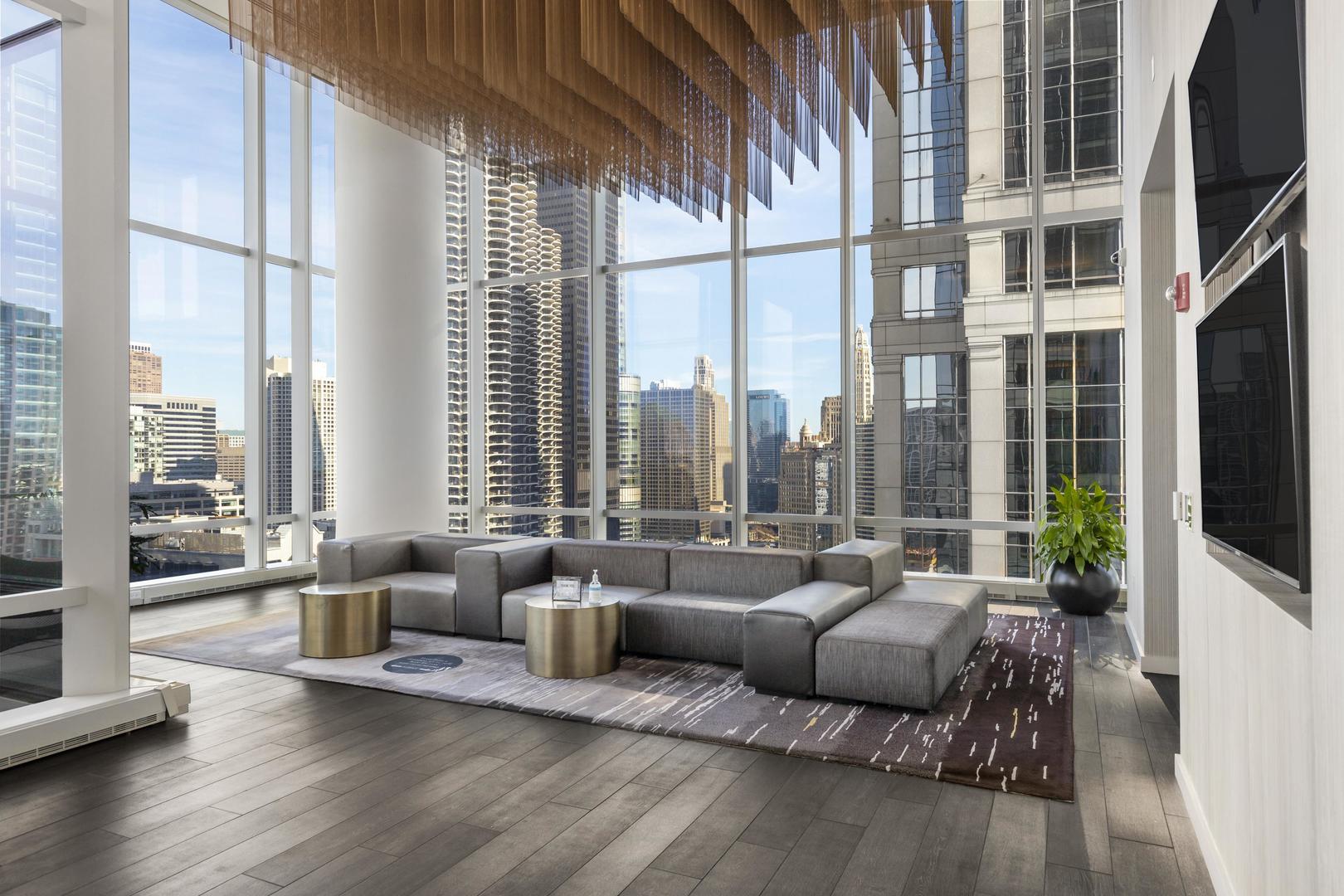 111 West Wacker Drive, Unit PH01 Chicago, IL 60601 - Photo 25 of 37 a living room with furniture and a large window