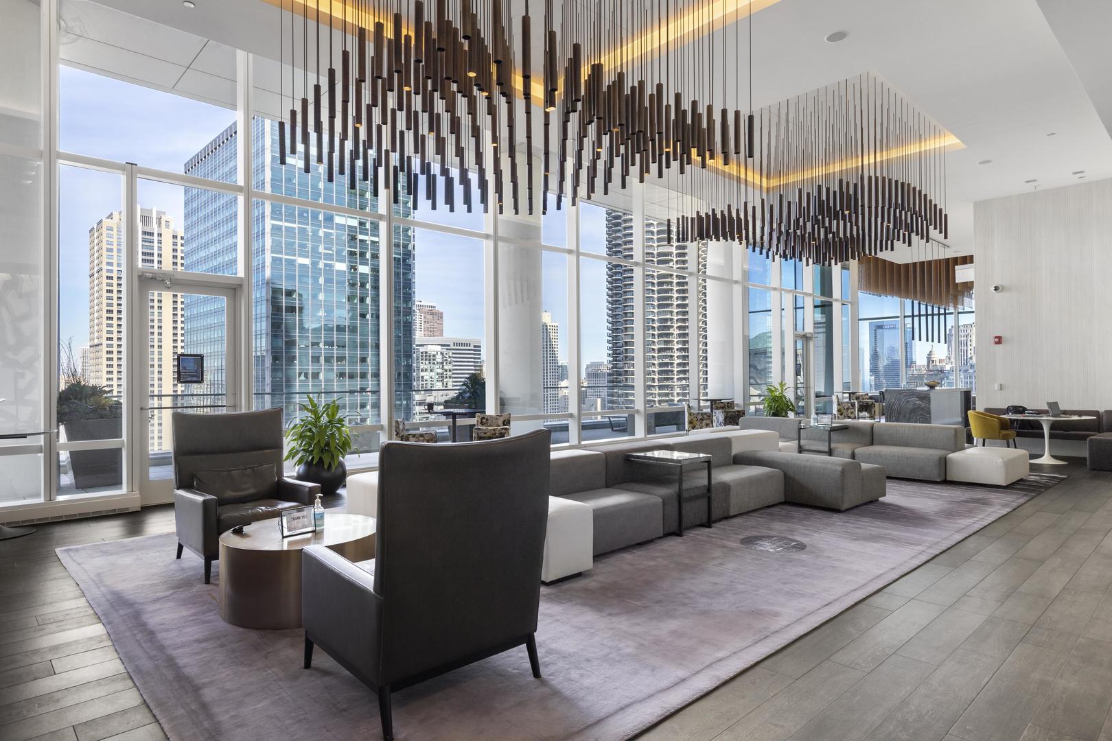 111 West Wacker Drive, Unit PH01 Chicago, IL 60601 - Photo 29 of 37 a living room with furniture and large windows