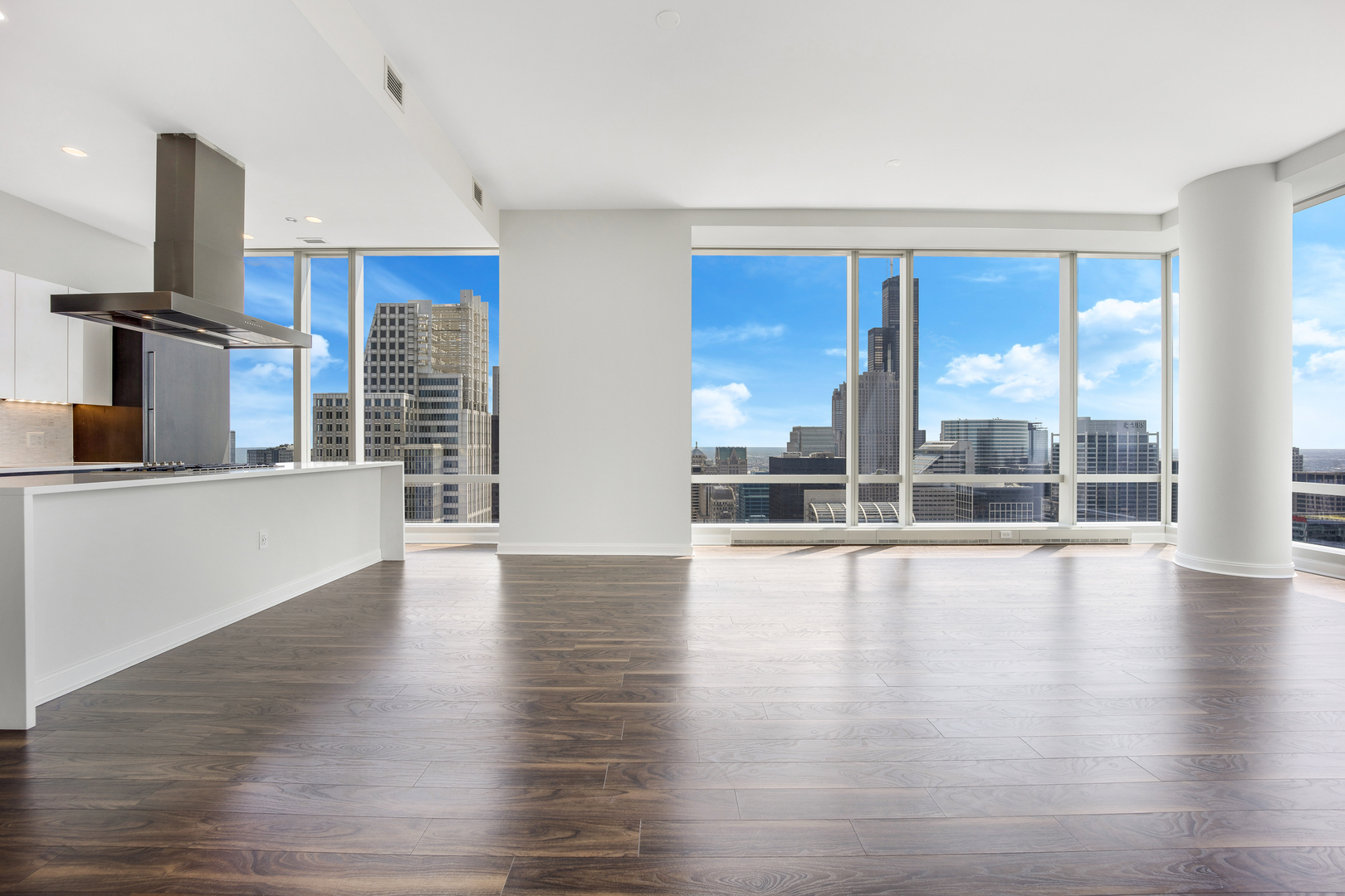 111 West Wacker Drive, Unit PH01 Chicago, IL 60601 - Photo 4 of 37 a view of an empty room with window and wooden floor