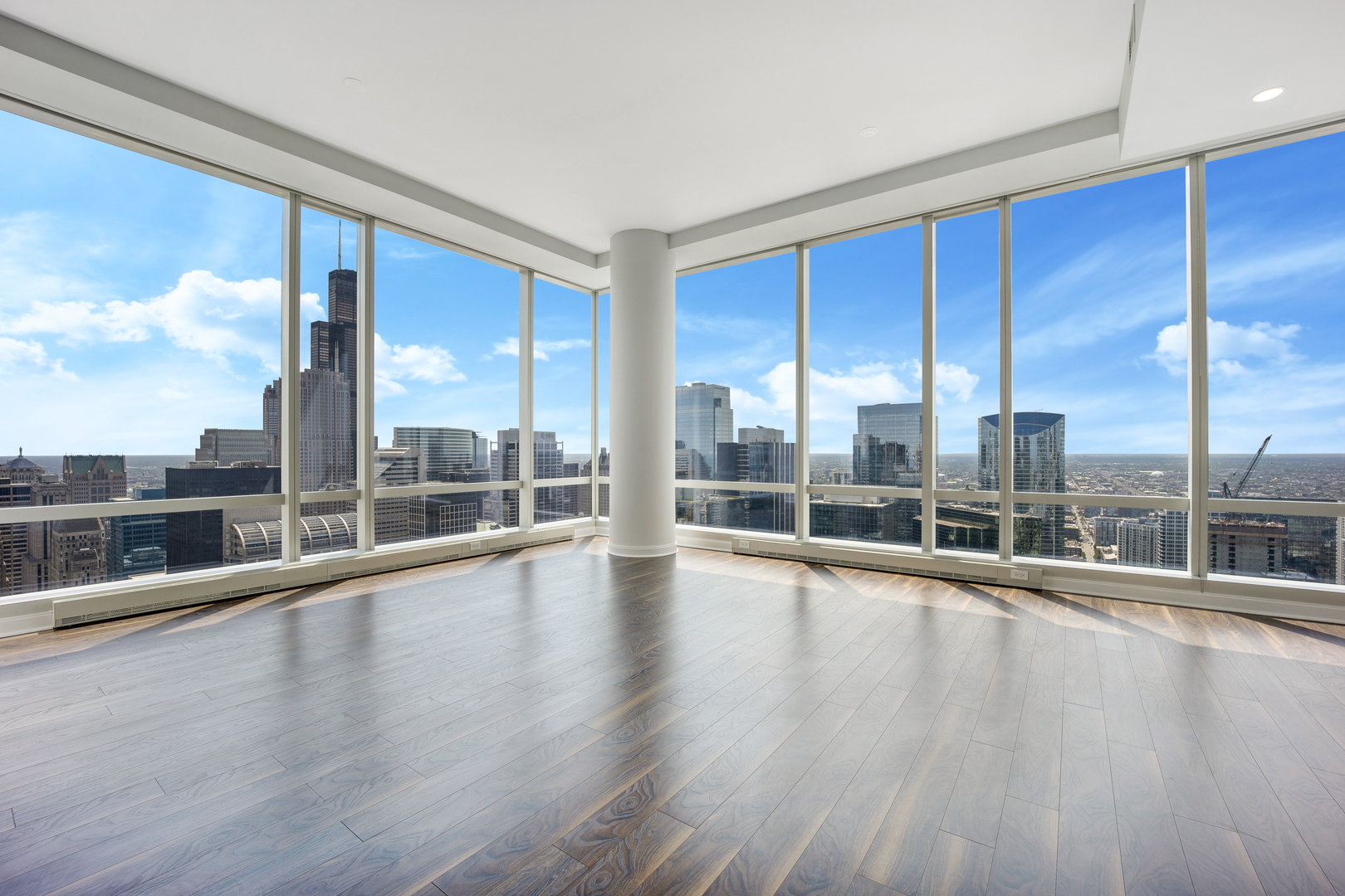 111 West Wacker Drive, Unit PH01 Chicago, IL 60601 - Photo 9 of 37 a view of an empty room with wooden floor and windows