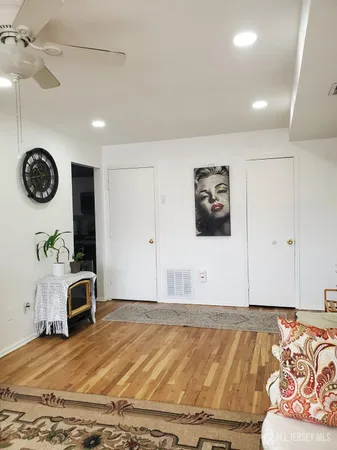 a view of a livingroom with furniture and ceiling fan