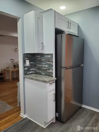 a kitchen with metallic refrigerator freezer and a dishwasher