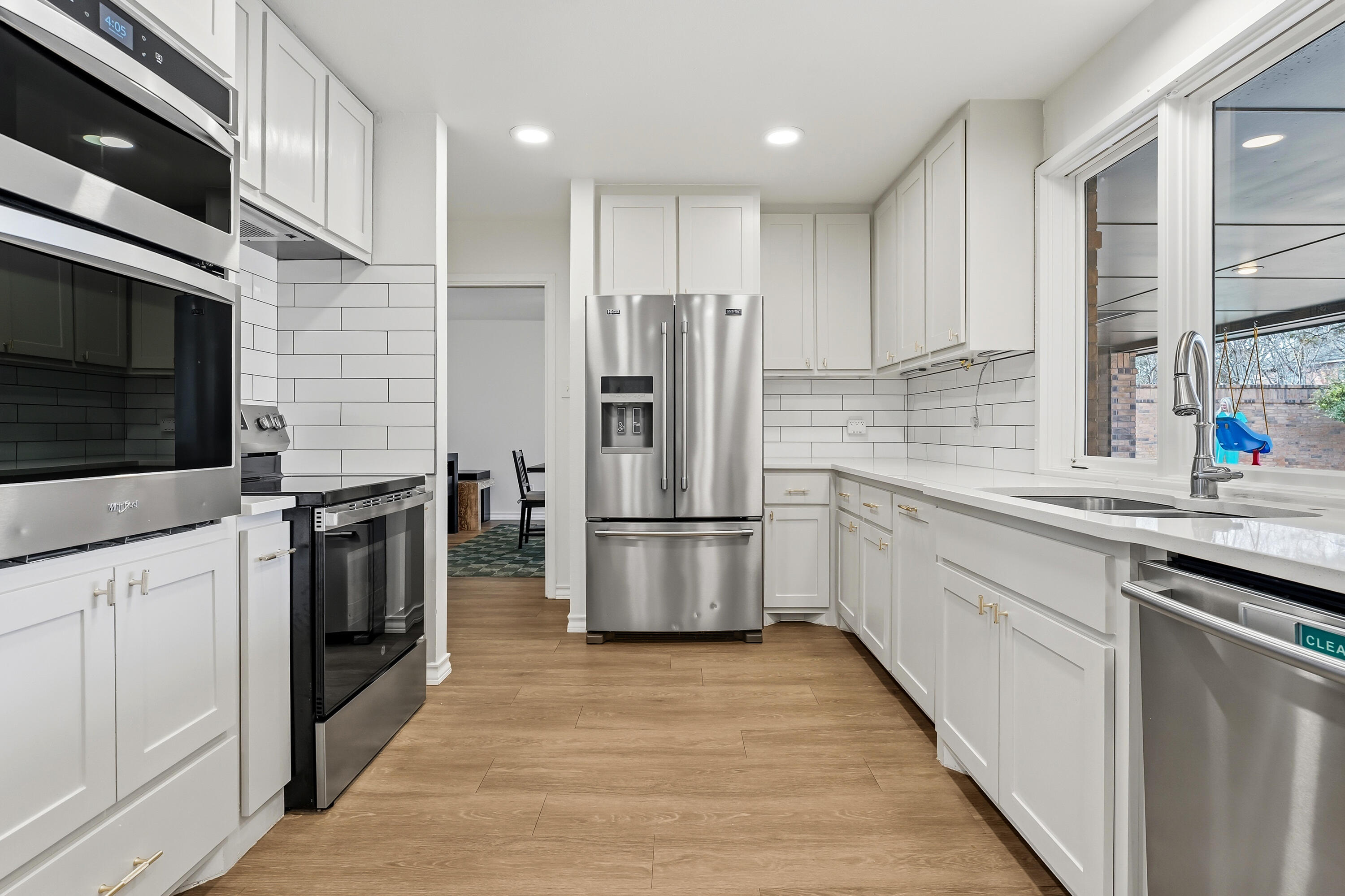 4628 94th Street Lubbock, TX 79424 - Photo 14 of 41 a kitchen with stainless steel appliances kitchen island granite countertop a stove a sink and a refrigerator