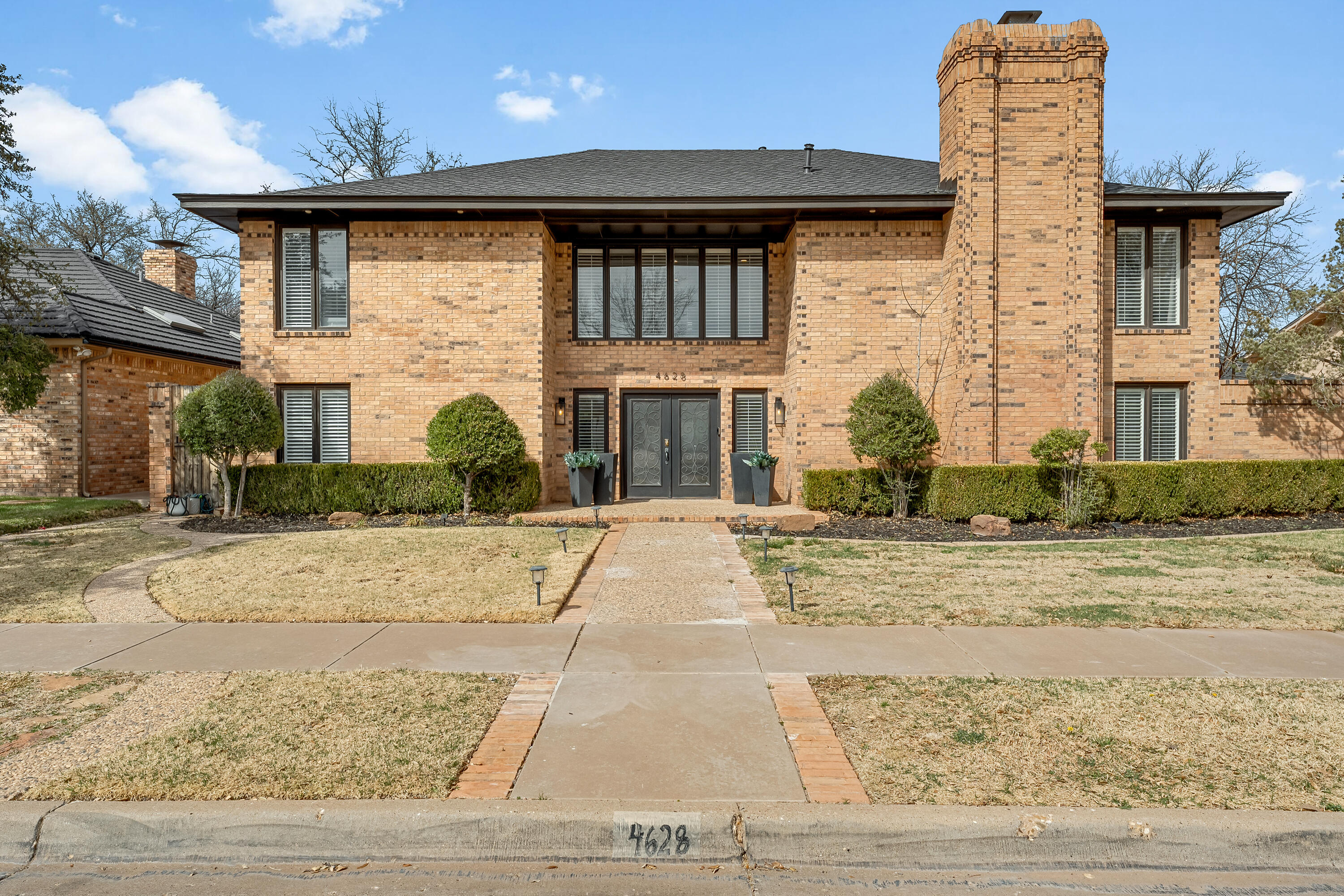 4628 94th Street Lubbock, TX 79424 - Photo 2 of 41 a front view of a house with a yard