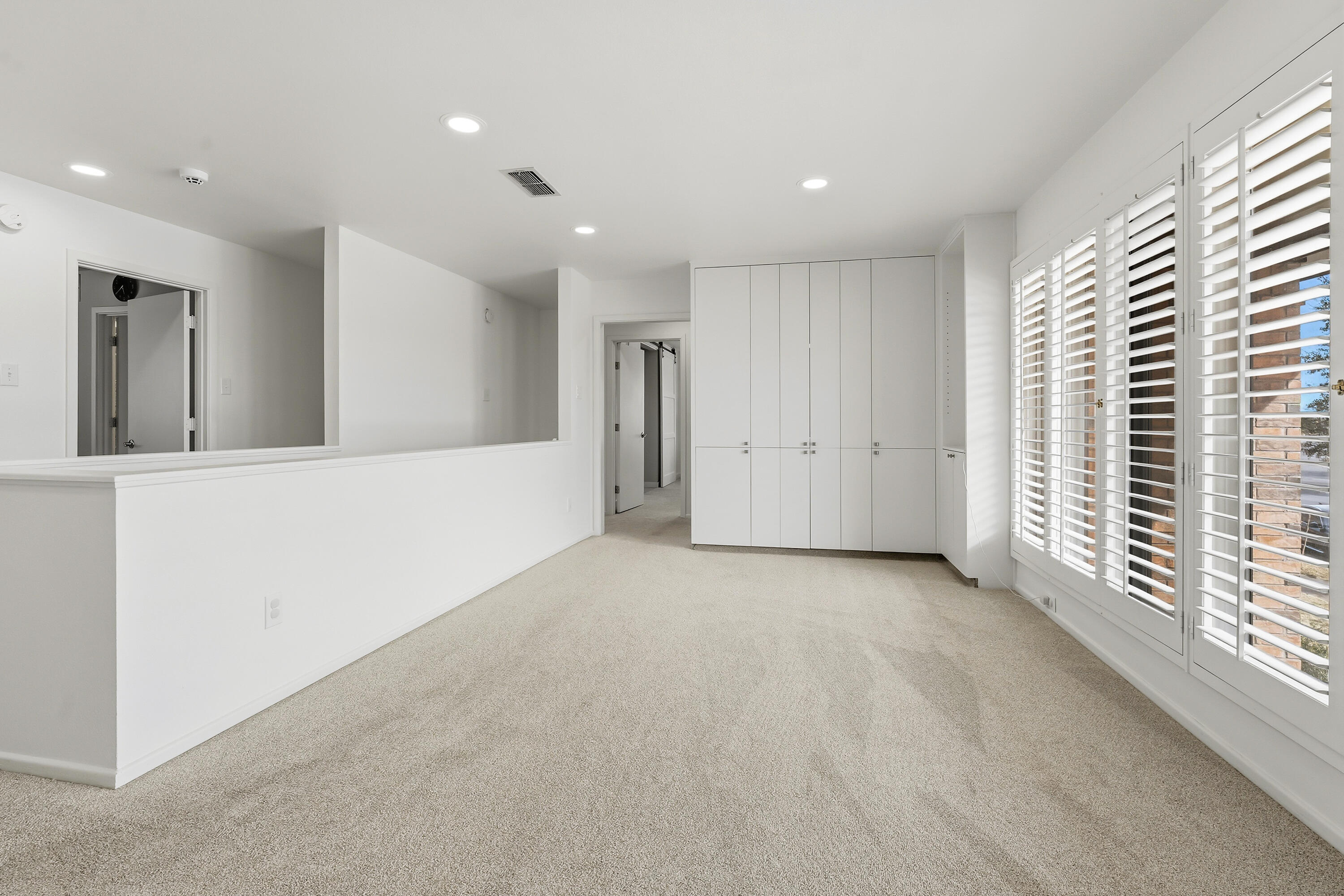 4628 94th Street Lubbock, TX 79424 - Photo 24 of 41 an empty room with a window and a kitchen