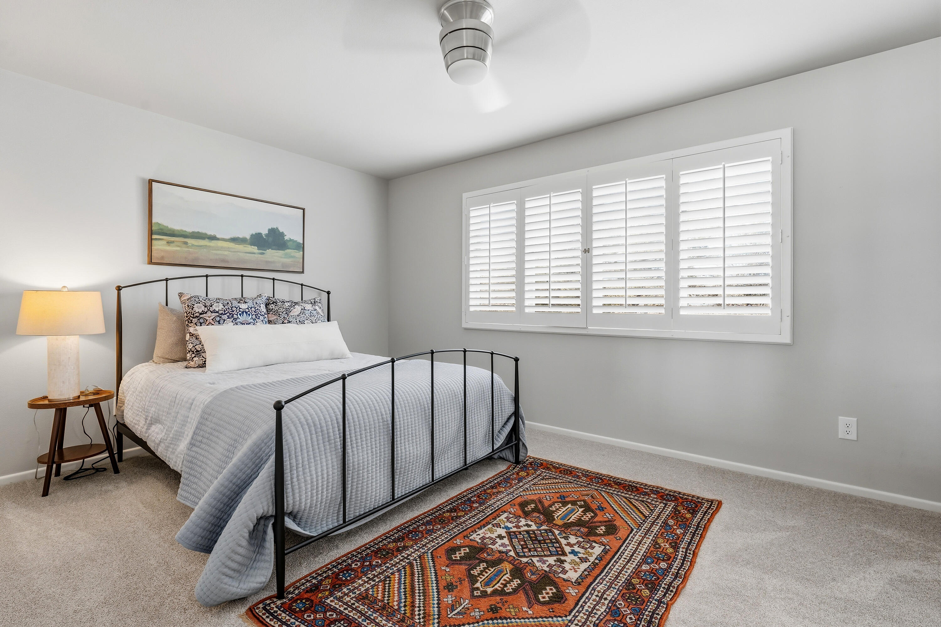 4628 94th Street Lubbock, TX 79424 - Photo 30 of 41 a bed sitting in a bedroom next to a window