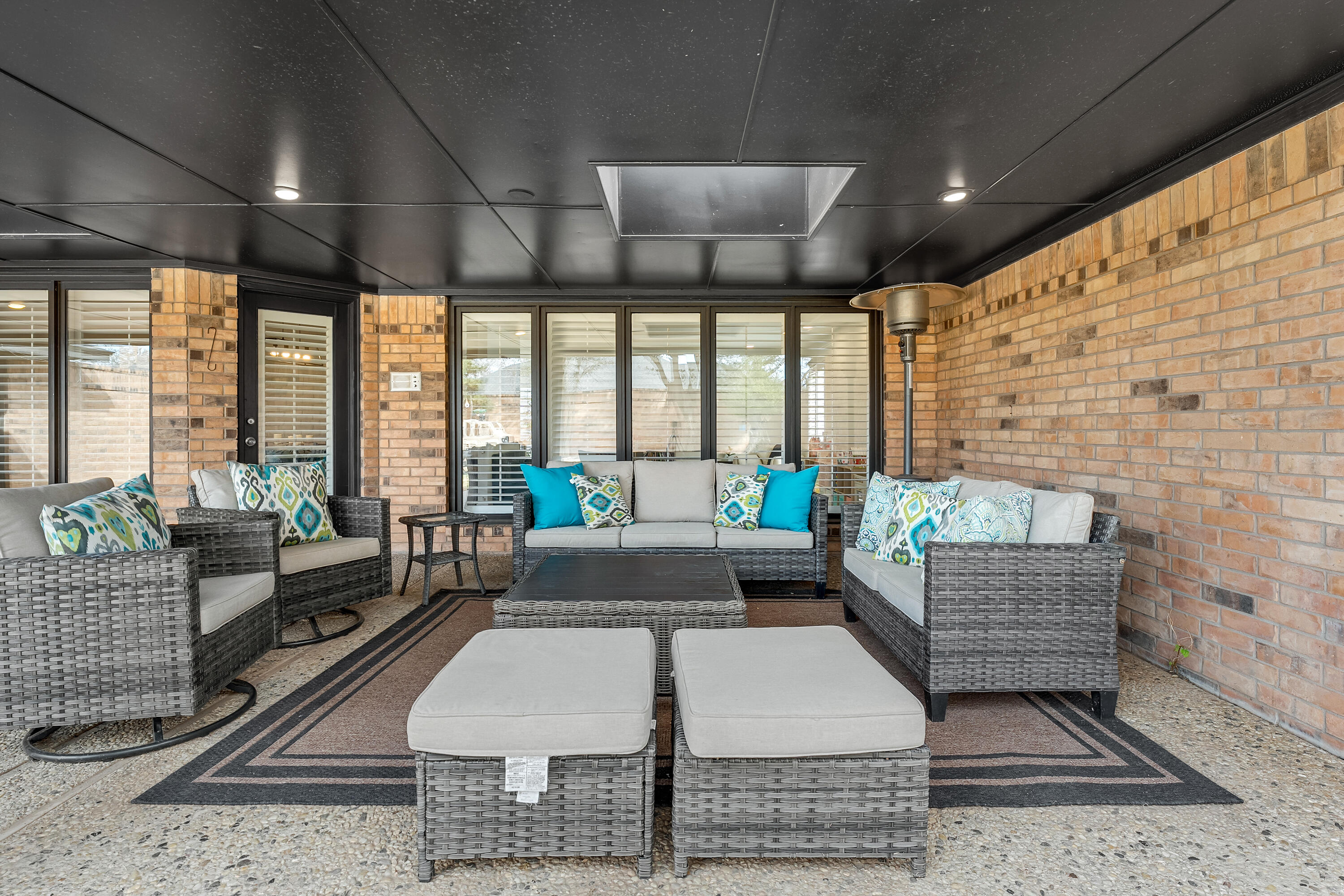 4628 94th Street Lubbock, TX 79424 - Photo 38 of 41 a living room with furniture and floor to ceiling windows