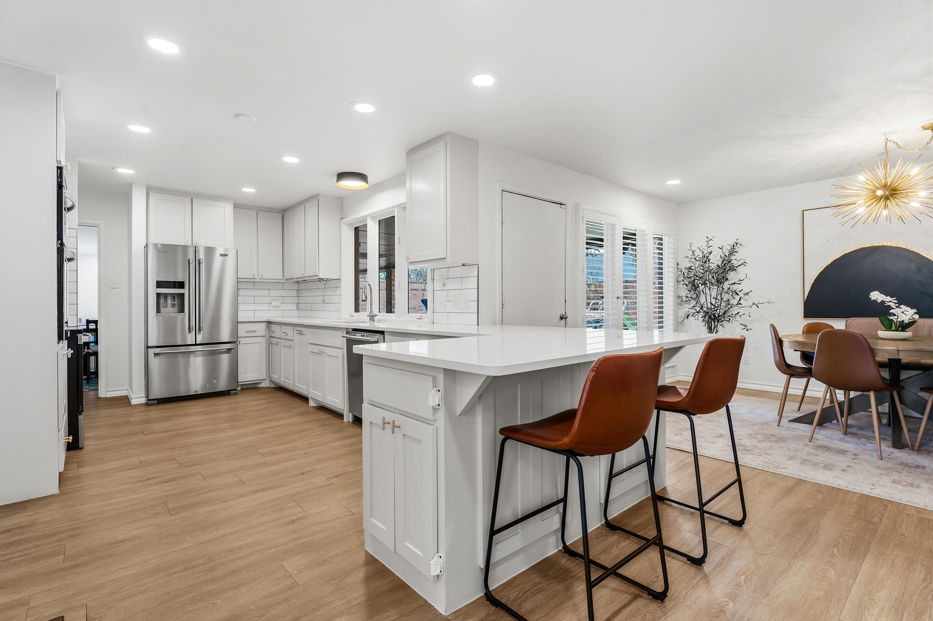 4628 94th Street Lubbock, TX 79424 - Photo 10 of 41 a kitchen with stainless steel appliances kitchen island granite countertop a table chairs sink and cabinets