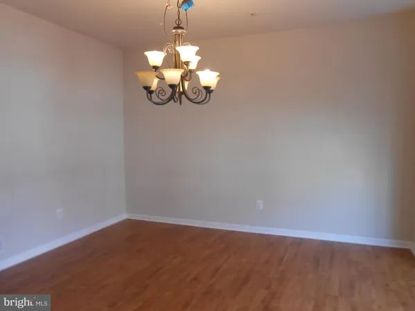 a view of a chandelier fan and hardwood floor