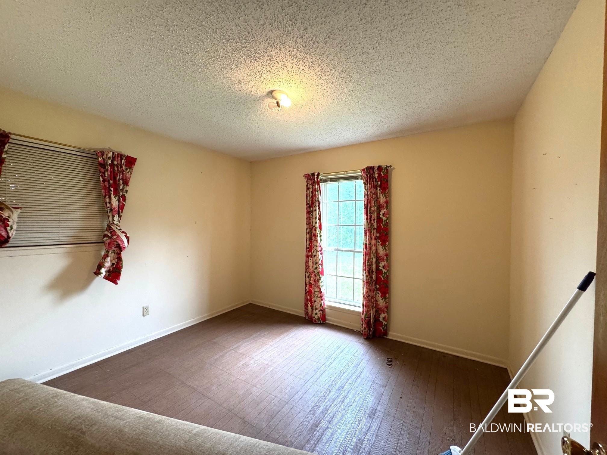 5198 Lancelot Drive Mobile, AL 36619 - Photo 11 of 30 Spare room featuring a textured ceiling and wood finished floors