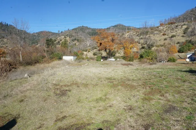 a view of mountain with trees in the background