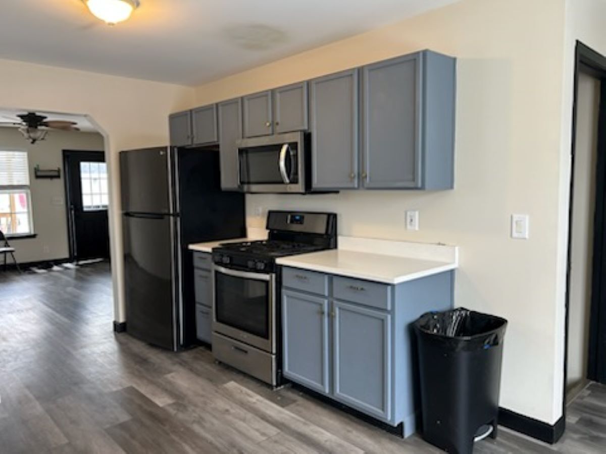 711 Prospect Street Kirkland, IL 60146 - Photo 4 of 23 a kitchen with a refrigerator stove and wooden cabinets