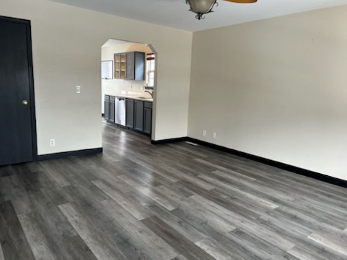 711 Prospect Street Kirkland, IL 60146 - Photo 6 of 23 a view of kitchen and empty room with wooden floor
