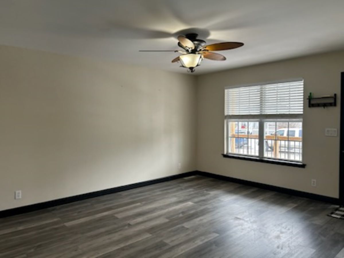 711 Prospect Street Kirkland, IL 60146 - Photo 9 of 23 an empty room with wooden floor fan and windows