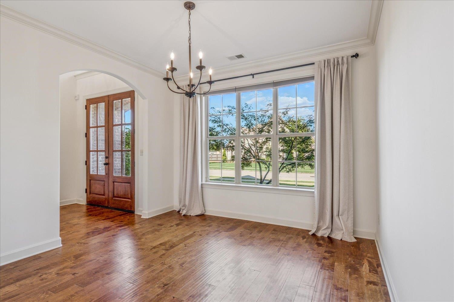 1349 Beautiful Place Collierville, TN 38017 - Photo 16 of 40 a view of livingroom with window chandelier and wooden floor