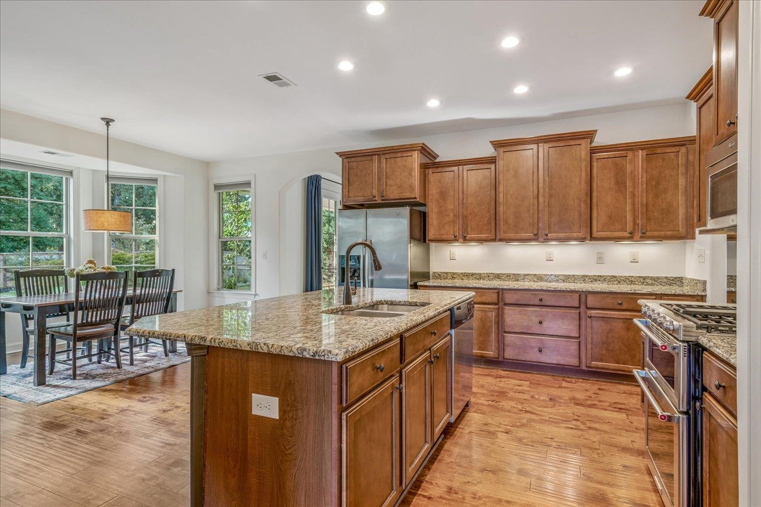 1349 Beautiful Place Collierville, TN 38017 - Photo 21 of 40 a kitchen with stainless steel appliances granite countertop a stove a sink a oven a dining table and chairs