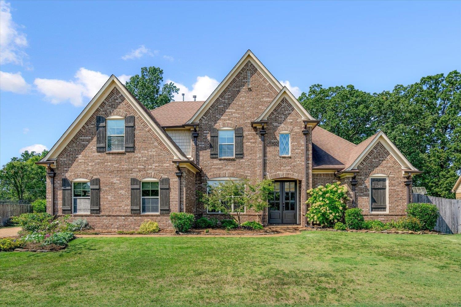 1349 Beautiful Place Collierville, TN 38017 - Photo 3 of 40 a front view of a house with a yard and garage