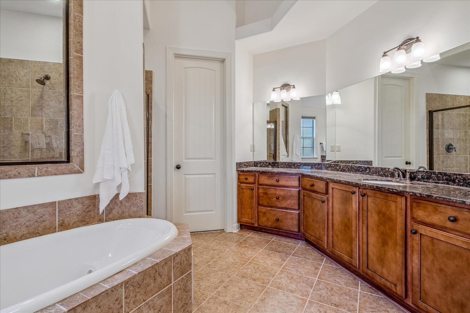 1349 Beautiful Place Collierville, TN 38017 - Photo 31 of 40 a bathroom with a tub a sink and a mirror