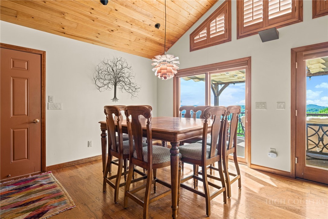 331 Alpine Road Blowing Rock, NC 28605 - Photo 17 of 50 a view of a dining room with furniture a chandelier and wooden floor