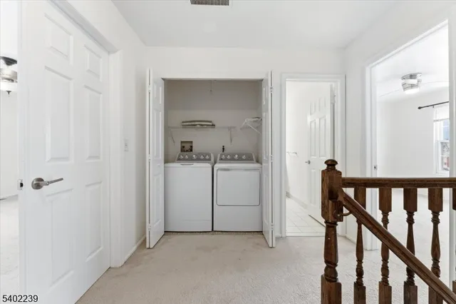 a view of a hallway with a hallway and a livingroom with a chair