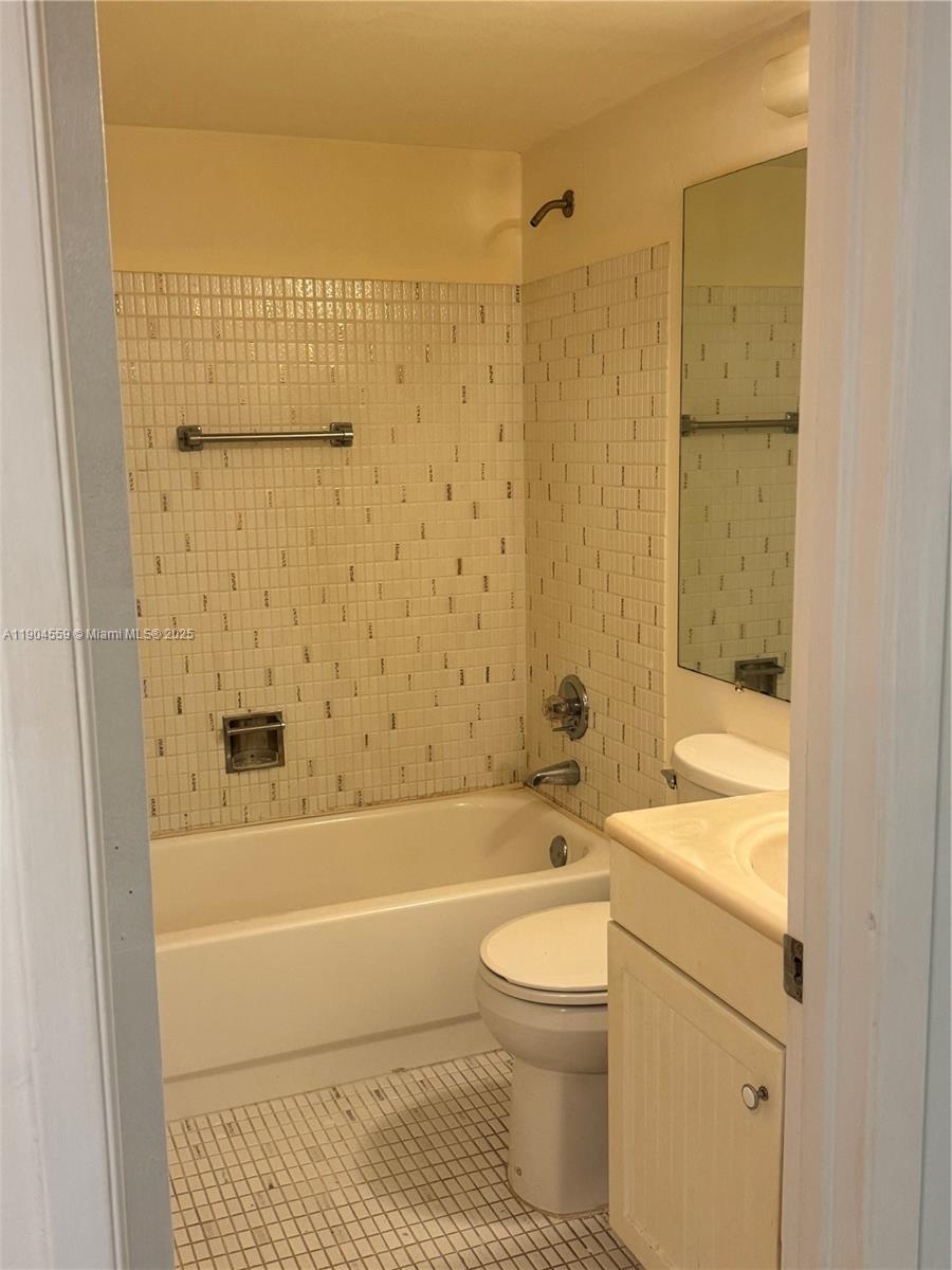 5640 Southwest 3rd Place, Unit 110 Margate, FL 33068 - Photo 23 of 28 a bathroom with a bathtub and a toilet