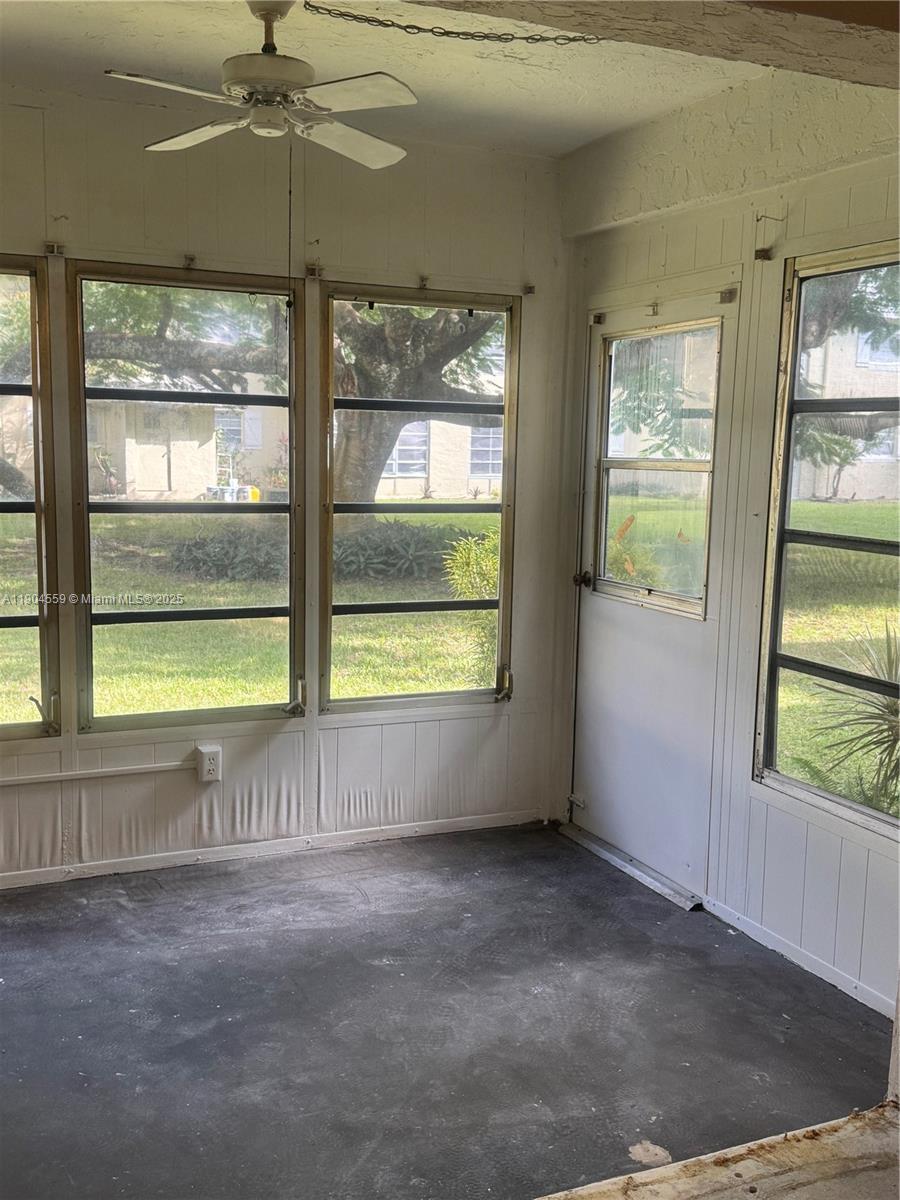 5640 Southwest 3rd Place, Unit 110 Margate, FL 33068 - Photo 26 of 28 an empty room with windows and ceiling fan