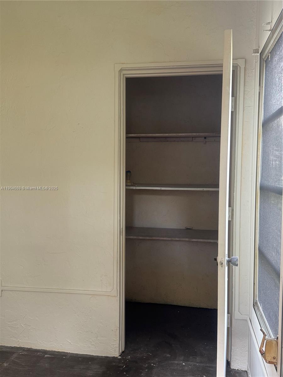 5640 Southwest 3rd Place, Unit 110 Margate, FL 33068 - Photo 28 of 28 a view of walk in closet with empty racks