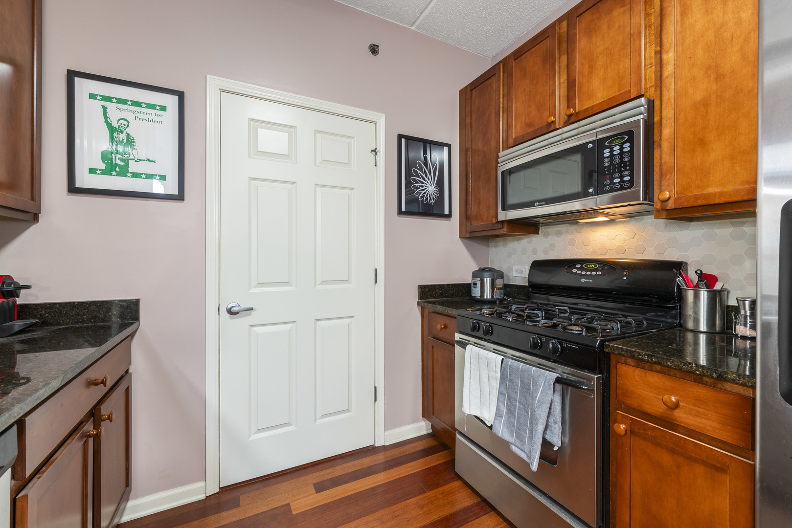 9530 Cook Avenue, Unit 211 Oak Lawn, IL 60453 - Photo 11 of 34 a kitchen with stainless steel appliances granite countertop a stove microwave and sink