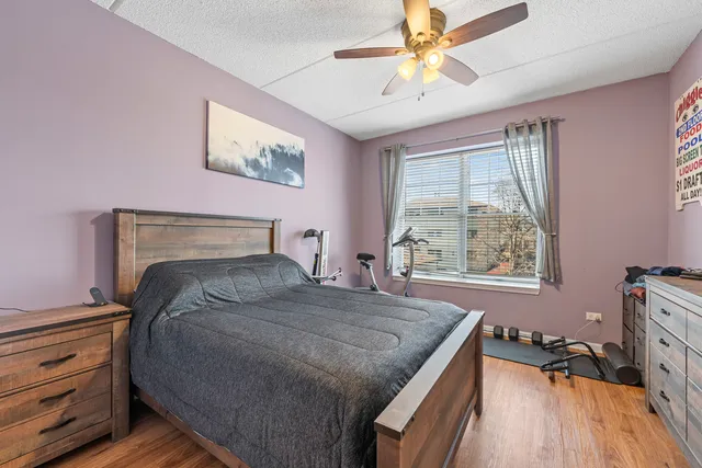 a bed room with a bed and a chair