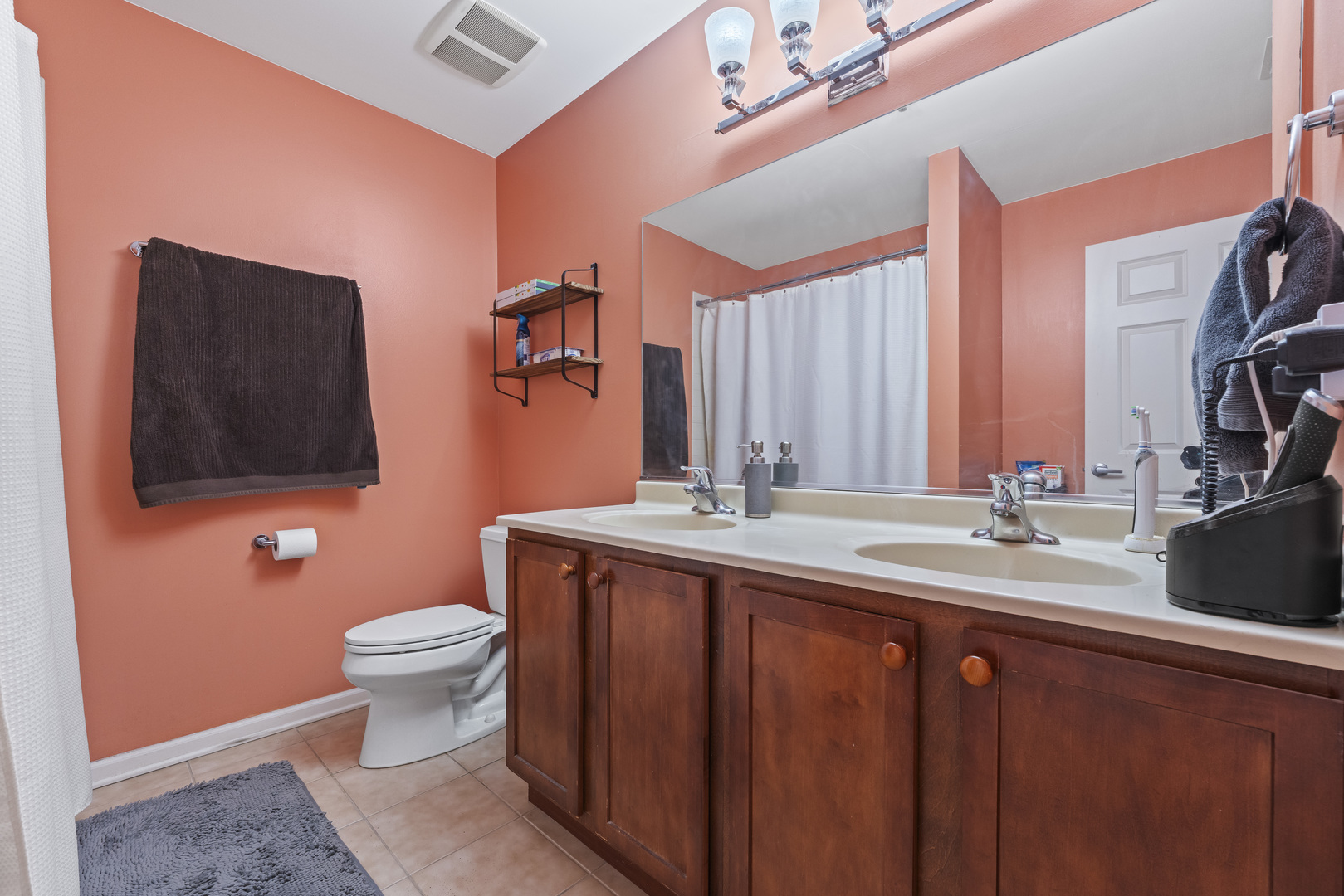 9530 Cook Avenue, Unit 211 Oak Lawn, IL 60453 - Photo 15 of 34 a bathroom with a toilet sink and mirror