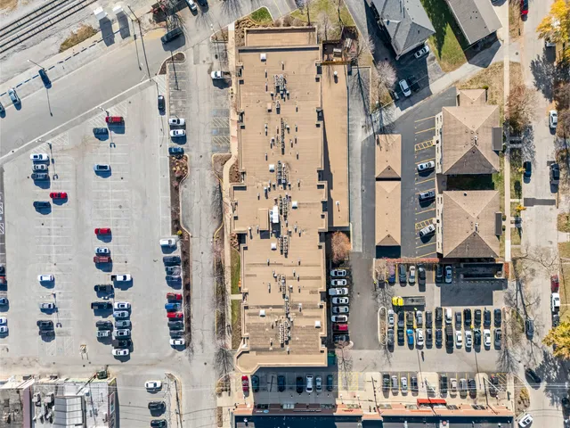 a city view with lot of cars parked in front of house