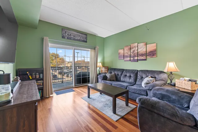 a living room with furniture and a floor to ceiling window
