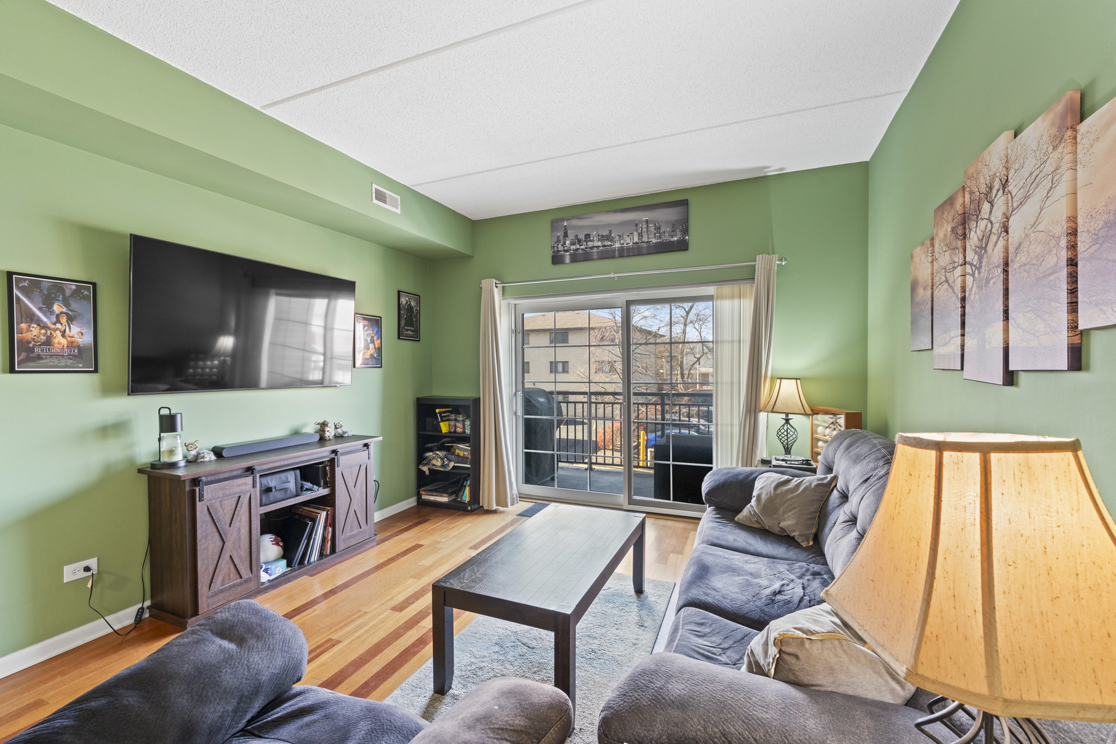 9530 Cook Avenue, Unit 211 Oak Lawn, IL 60453 - Photo 6 of 34 a living room with furniture and a flat screen tv