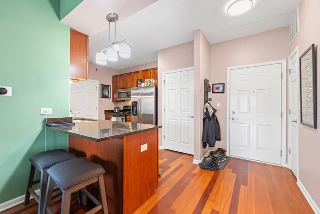 a dining hall with a dining table and chairs with wooden floor