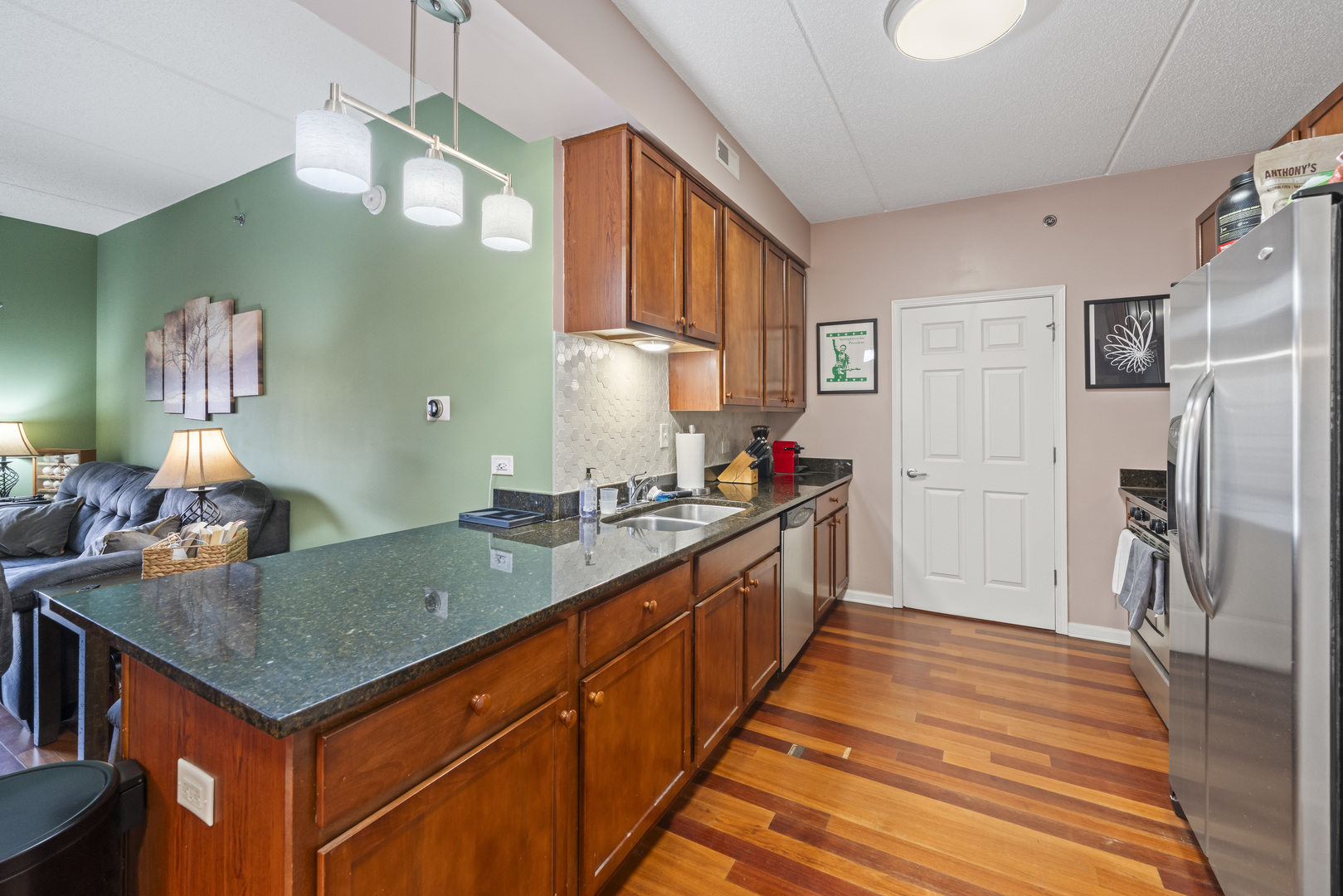 9530 Cook Avenue, Unit 211 Oak Lawn, IL 60453 - Photo 9 of 34 a kitchen with stainless steel appliances granite countertop a sink and refrigerator