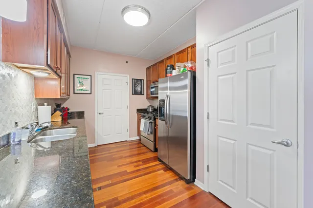 a kitchen with stainless steel appliances granite countertop a stove microwave and sink