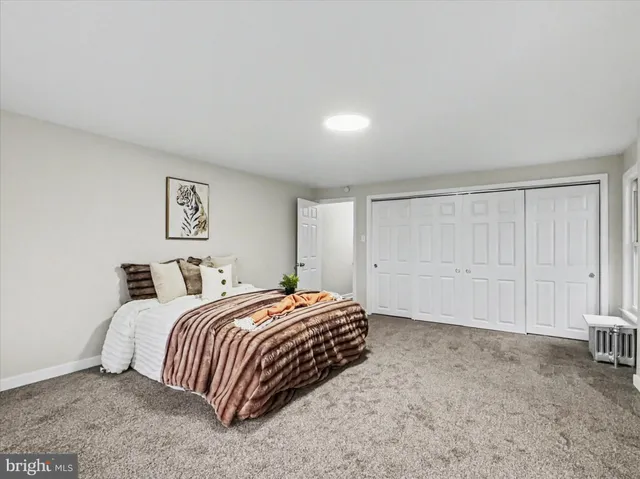 a bedroom with a bed and a large window