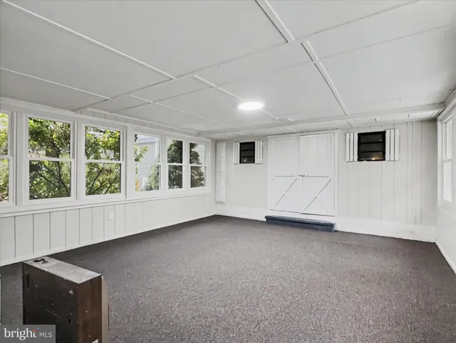 a kitchen with wooden floors white cabinets and stainless steel appliances