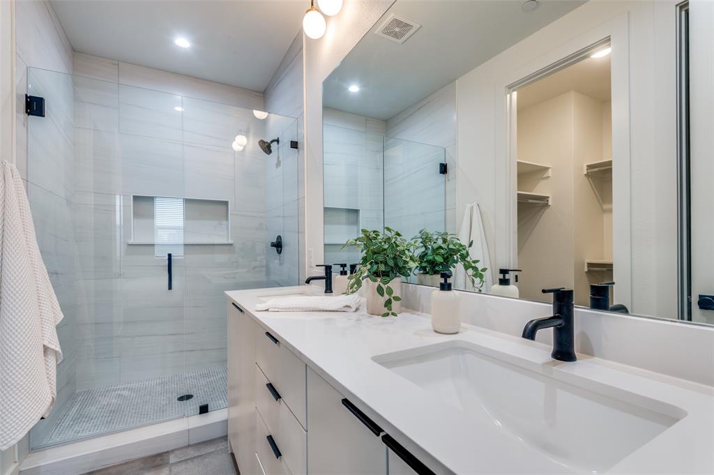 1147 North Madison Avenue, Unit 102 Dallas, TX 75208 - Photo 13 of 24 Dual vanity with modern walk-in shower.