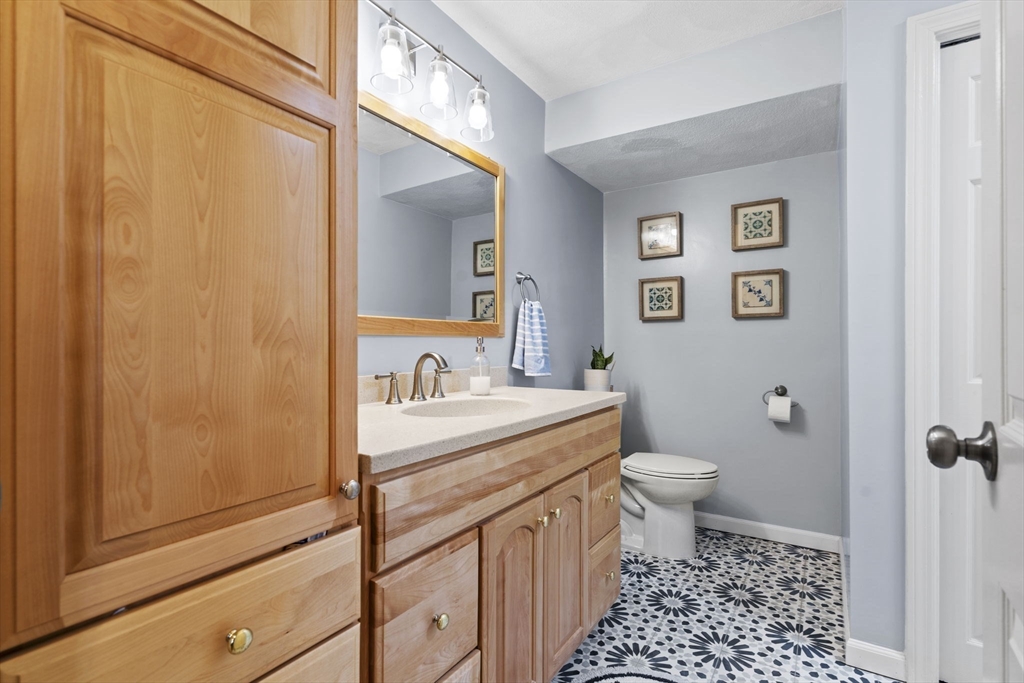 4 Apple Ridge Road, Unit 6 Maynard, MA 01754 - Photo 15 of 40 a bathroom with a granite countertop sink toilet and shower