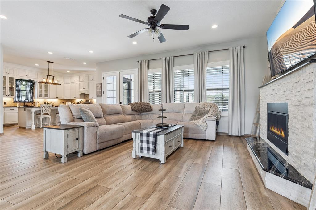 345 Cypress Isles Road Osteen, FL 32764 - Photo 8 of 41 a living room with furniture fireplace and flat screen tv
