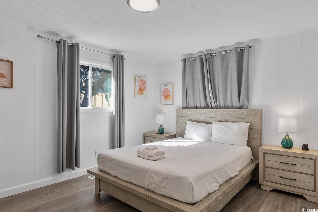 409 17th Avenue North, Unit 4 Myrtle Beach, SC 29577 - Photo 16 of 22 Bedroom featuring wood finished floors and baseboards