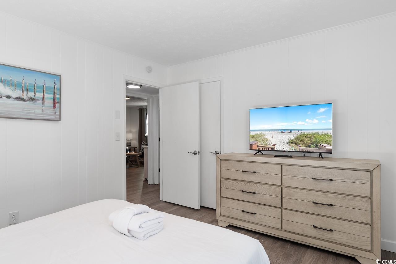 409 17th Avenue North, Unit 4 Myrtle Beach, SC 29577 - Photo 18 of 22 Bedroom with dark wood finished floors