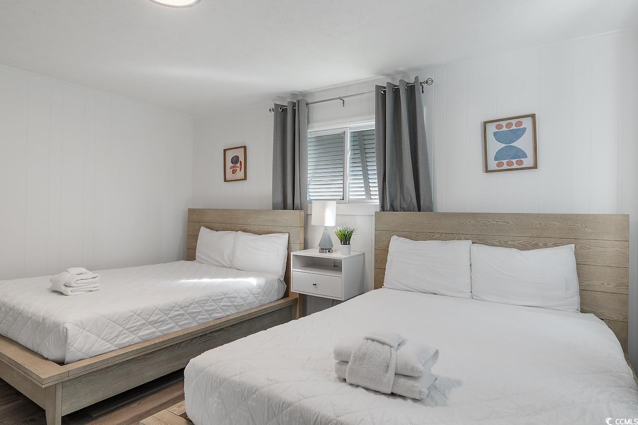 409 17th Avenue North, Unit 4 Myrtle Beach, SC 29577 - Photo 19 of 22 Bedroom featuring wooden walls and wood finished floors
