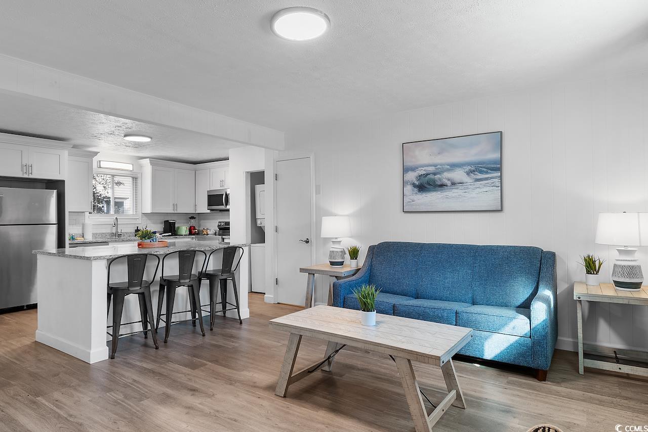 409 17th Avenue North, Unit 4 Myrtle Beach, SC 29577 - Photo 3 of 22 Living room with light wood-style floors and a textured ceiling