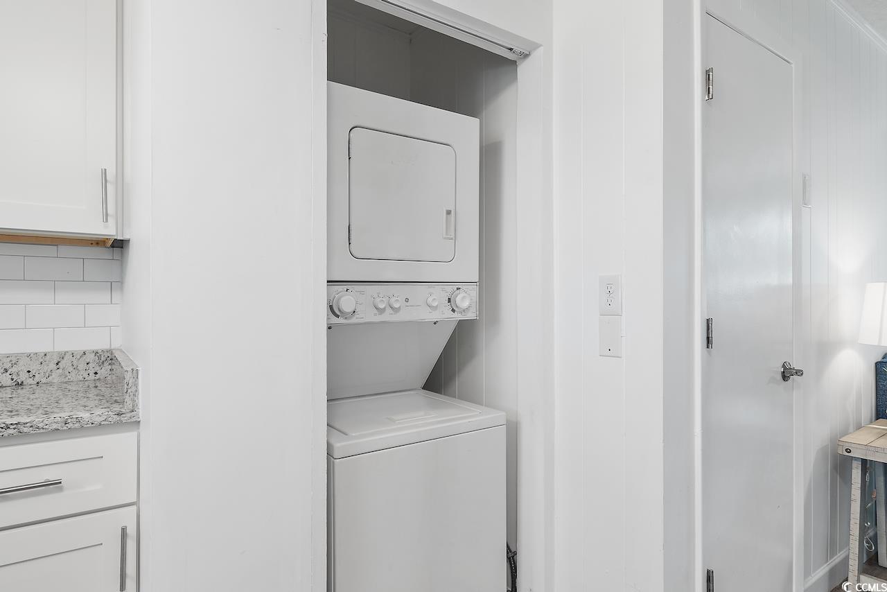 409 17th Avenue North, Unit 4 Myrtle Beach, SC 29577 - Photo 9 of 22 Laundry area featuring stacked washer / drying machine
