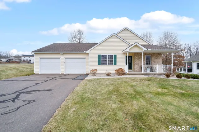 a front view of house with yard and green space