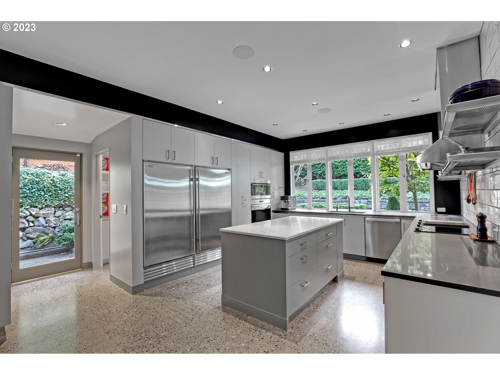 2122 Southwest Myrtle Street Portland, OR 97201 - Photo 25 of 47 a kitchen with counter top space sink and stainless steel appliances
